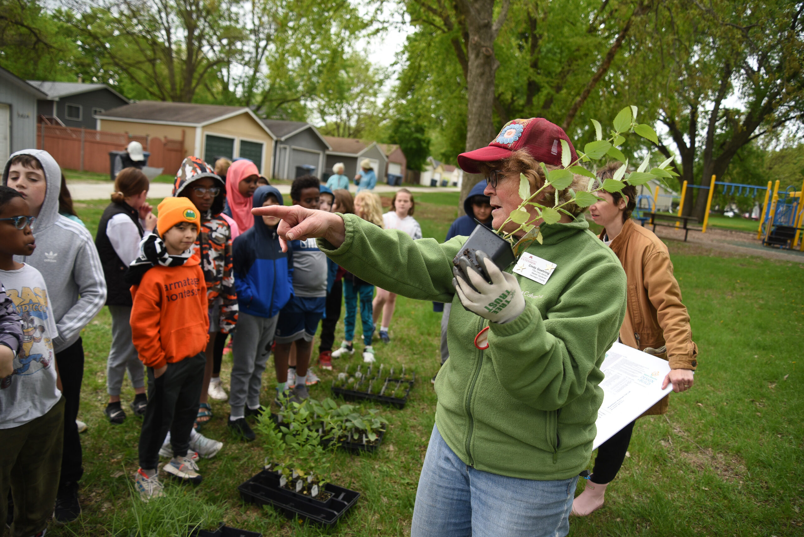 Armatage Elementary School students volunteer with U of M Extension educators and Armatage Neighborhood Association members to plant two pollinator gardens in Washburn Ave. Totlot.